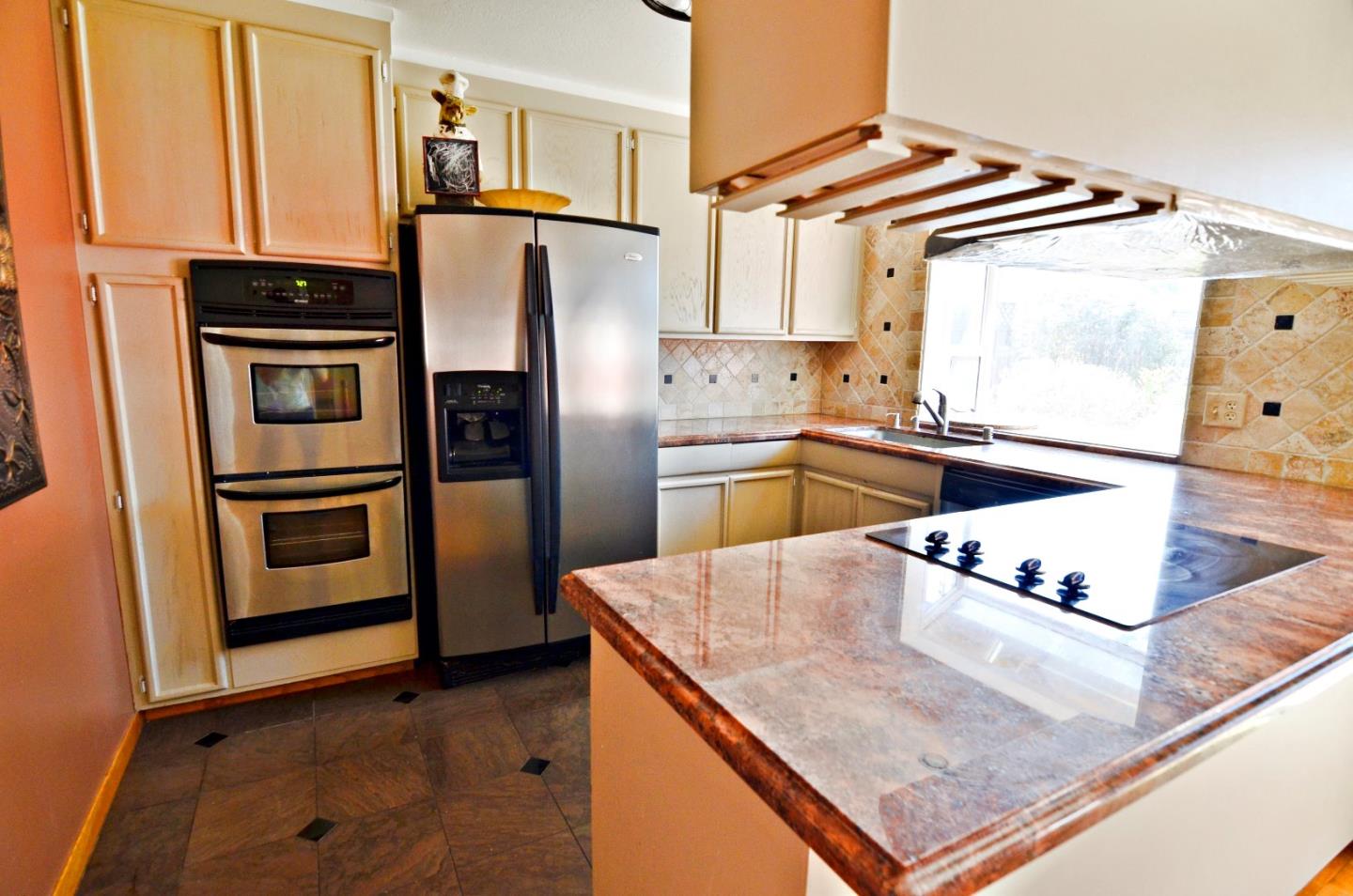 1920 Waycross Road Fremont, CA 94539 - Photo 7 of 13 a kitchen with stainless steel appliances granite countertop a refrigerator a stove and a sink with wooden floor