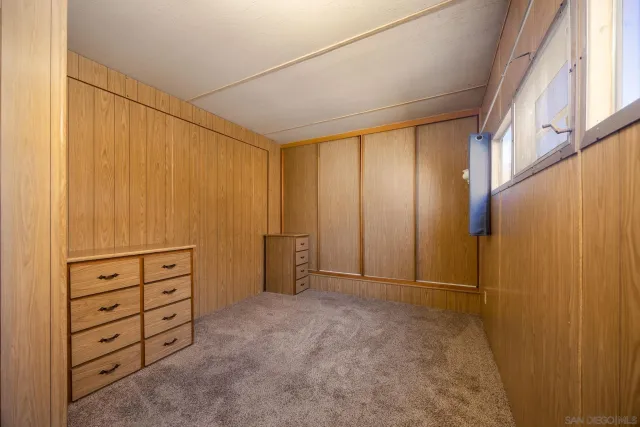 a bedroom with a bed and a television