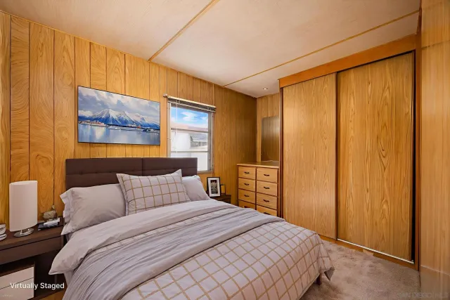 a bathroom with a granite countertop toilet sink and mirror