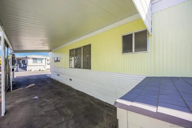 a front view of a house with plants