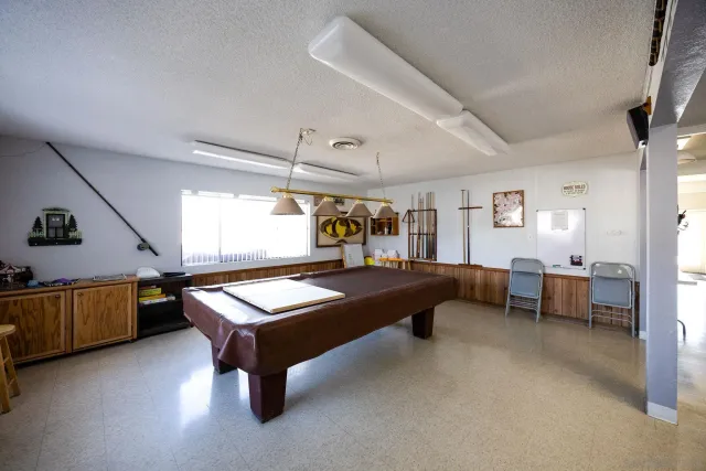 a bedroom with furniture and a book shelf