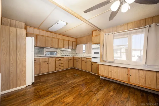 a kitchen with a cabinets wooden floor and a window