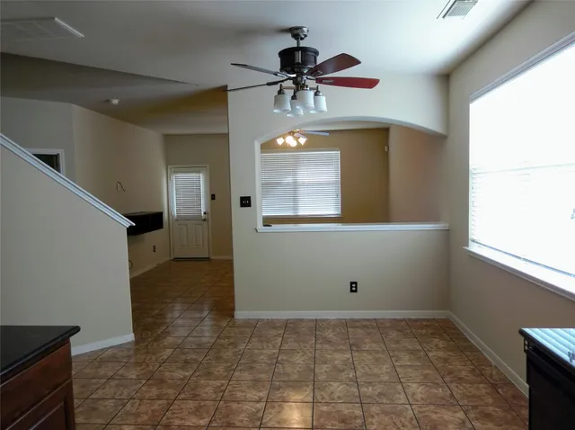 a view of a livingroom with a chandelier fan