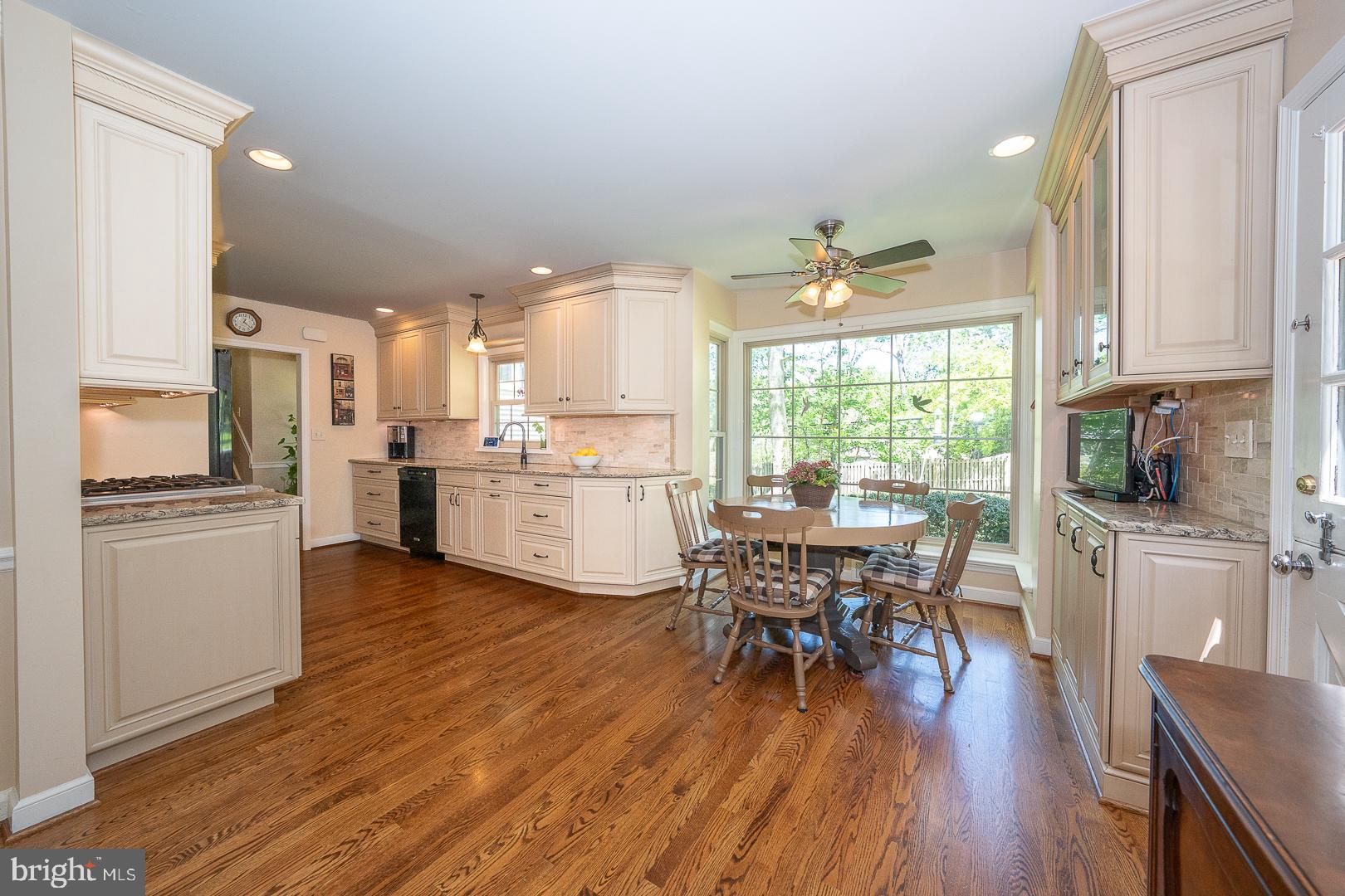 658 Conestoga Road Villanova, PA 19085 - Photo 8 of 57 a kitchen with stainless steel appliances a dining table chairs refrigerator and sink