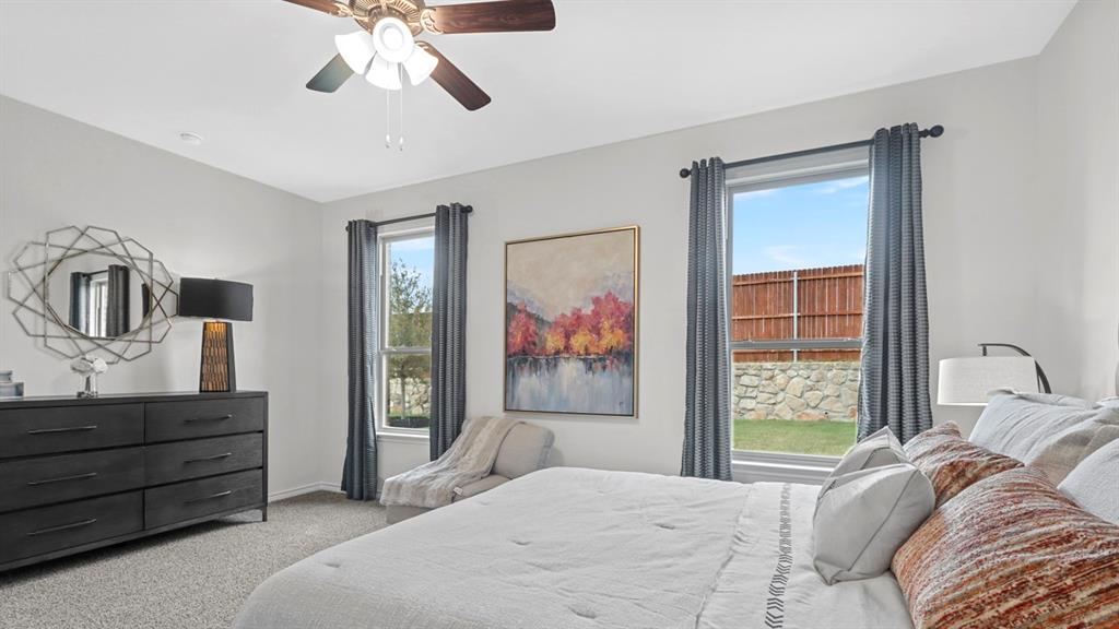 2000 Foggy Wds Lane Anna, TX 75409 - Photo 27 of 40 a bedroom with a bed and a chandelier