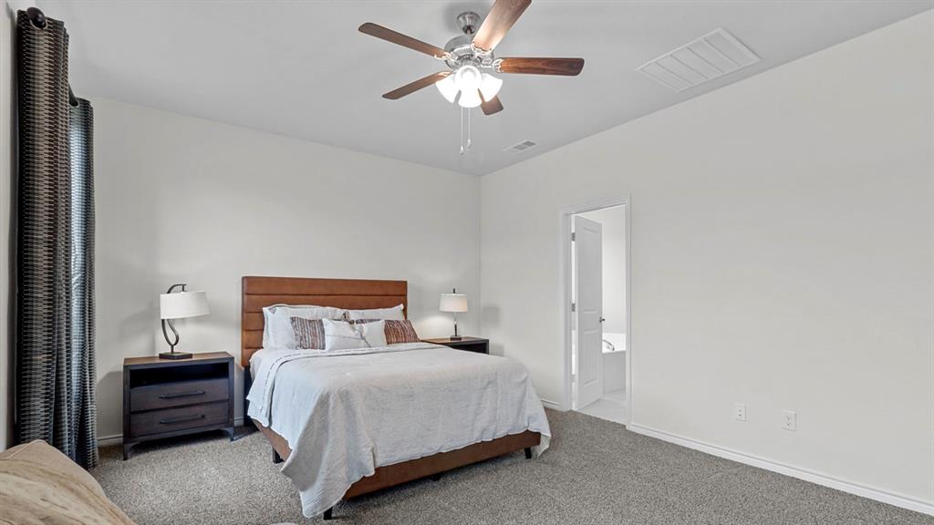2000 Foggy Wds Lane Anna, TX 75409 - Photo 29 of 40 a bedroom with a bed and a ceiling fan