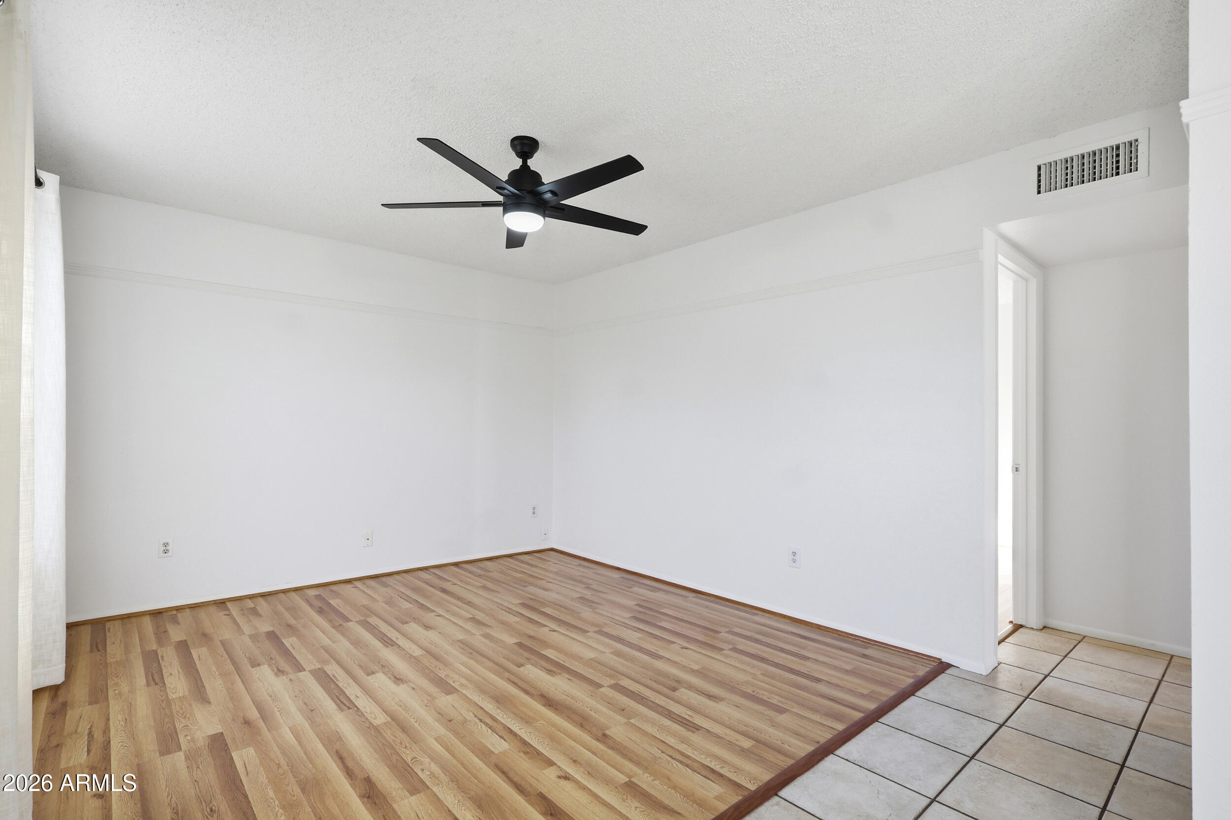 1033 East Bendix Drive Tempe, AZ 85283 - Photo 10 of 31 a view of a big room with wooden floor and windows