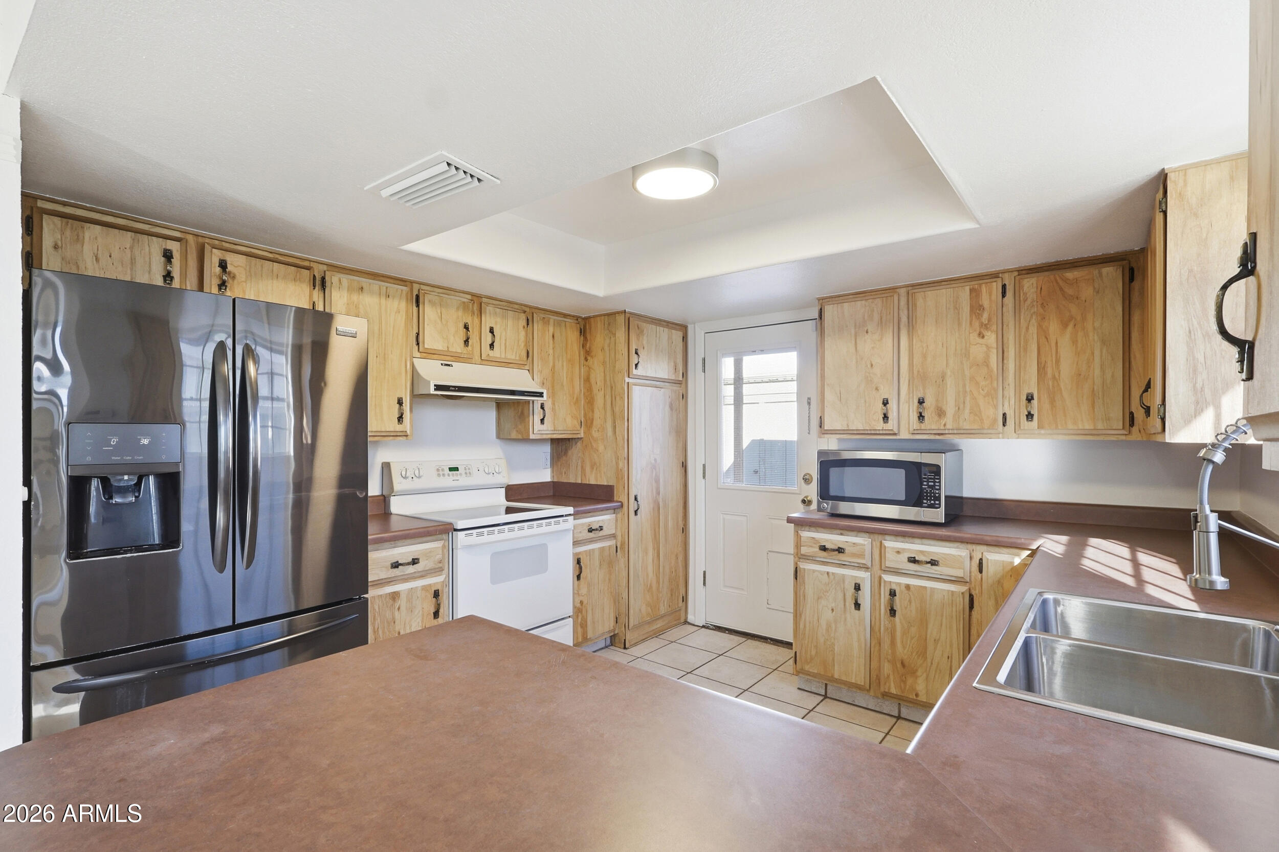 1033 East Bendix Drive Tempe, AZ 85283 - Photo 13 of 31 a kitchen with a refrigerator and a sink