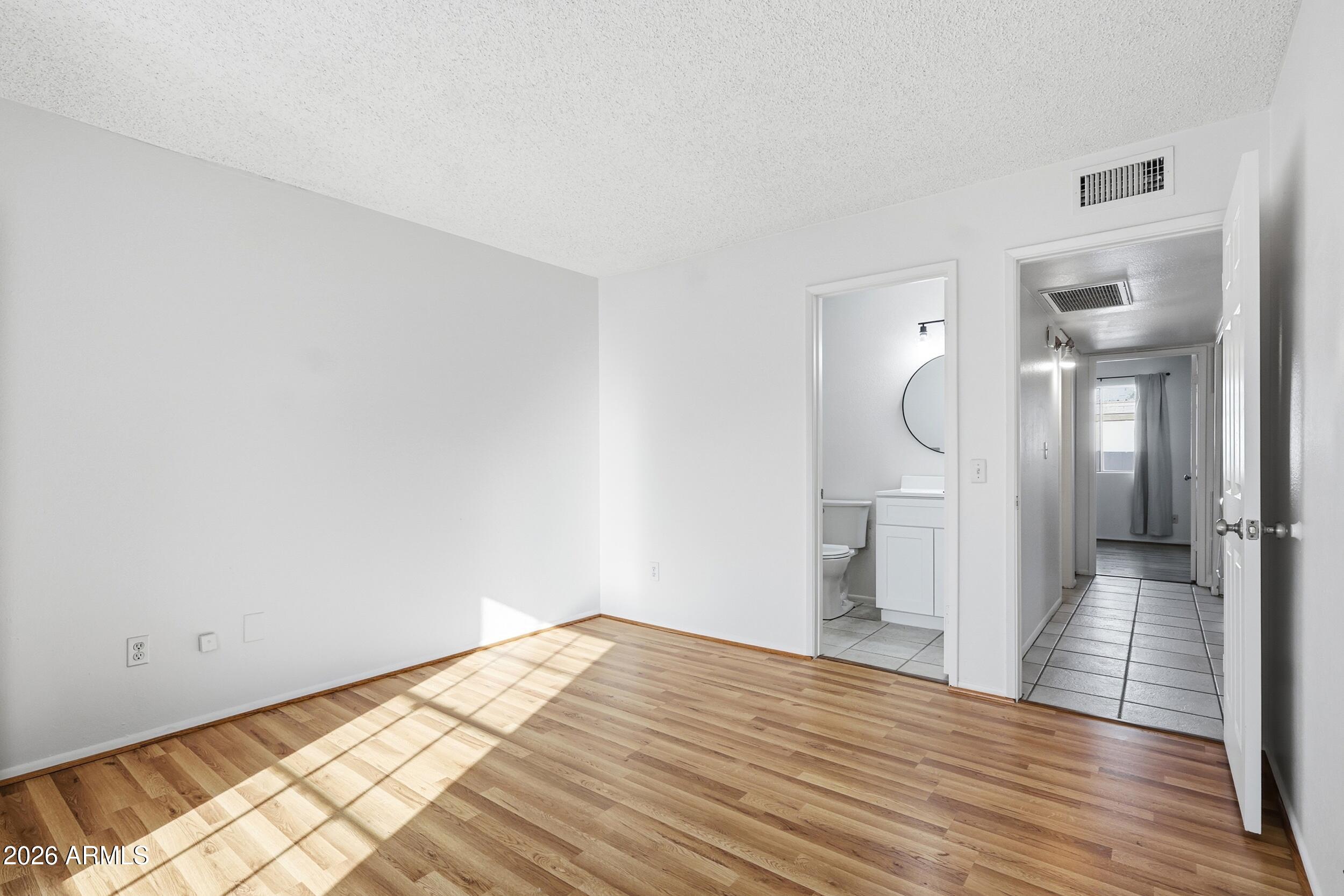 1033 East Bendix Drive Tempe, AZ 85283 - Photo 18 of 31 a view of empty room with wooden floor