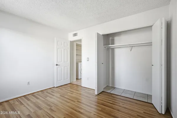 a view of empty room with wooden floor
