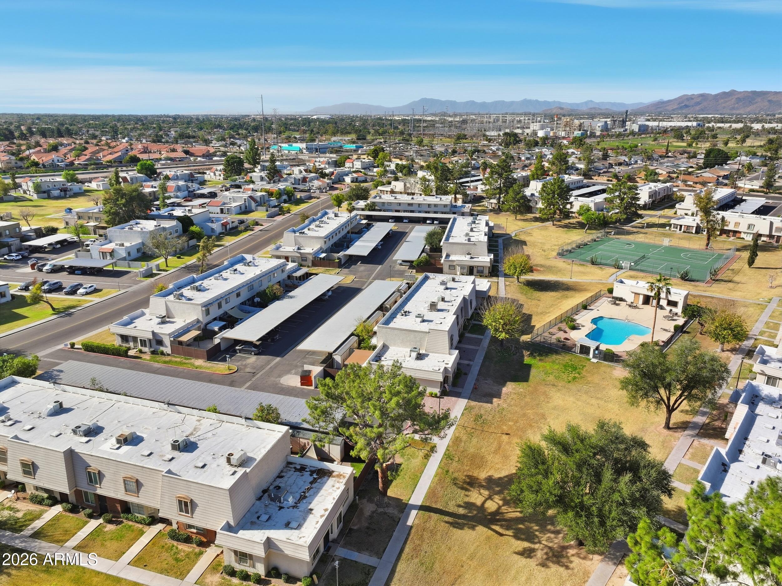 1033 East Bendix Drive Tempe, AZ 85283 - Photo 29 of 31 an aerial view of a city with lots of residential buildings and ocean view in back