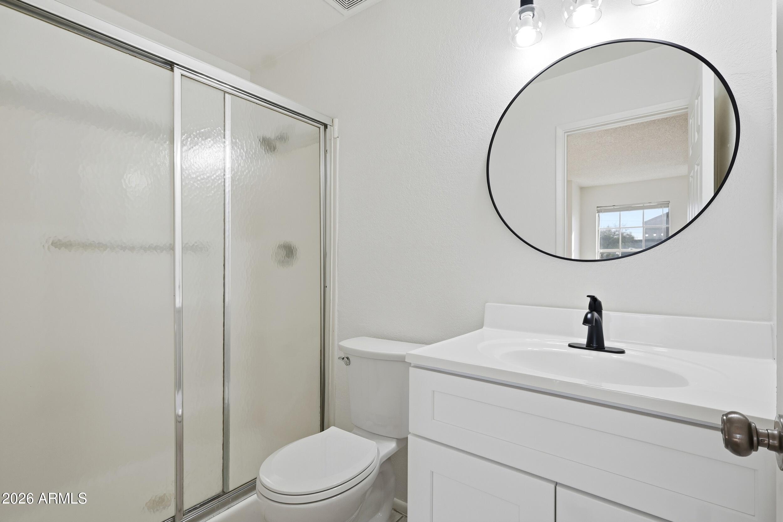 1033 East Bendix Drive Tempe, AZ 85283 - Photo 4 of 31 a bathroom with a sink a mirror a toilet and a mirror
