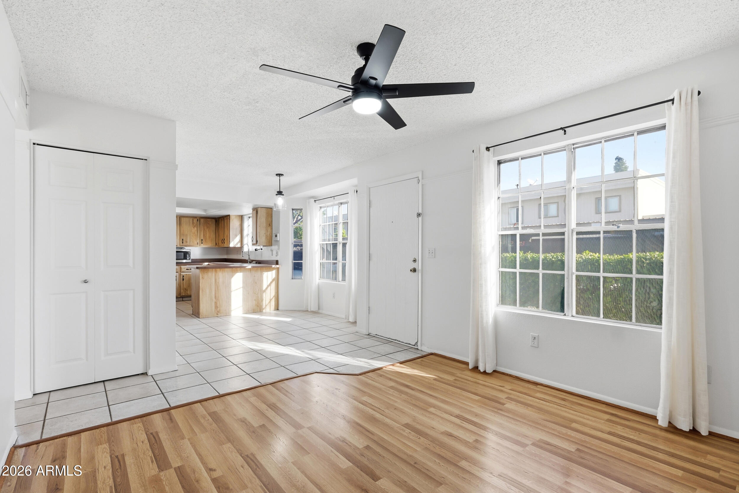 1033 East Bendix Drive Tempe, AZ 85283 - Photo 8 of 31 a view of a kitchen with wooden floor and a ceiling fan