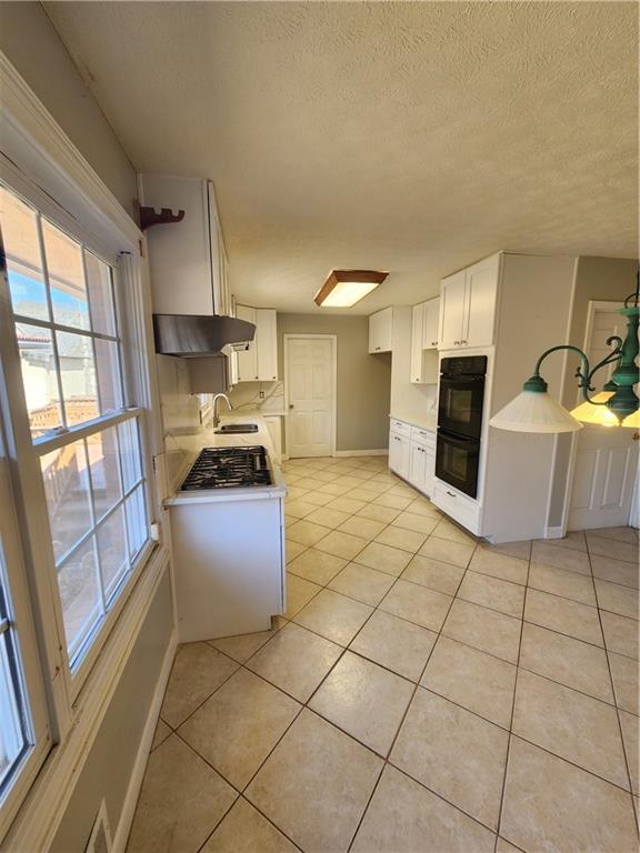 3258 Old Salem Road Southeast Conyers, GA 30013 - Photo 18 of 38 a kitchen with granite countertop a refrigerator and a stove top oven