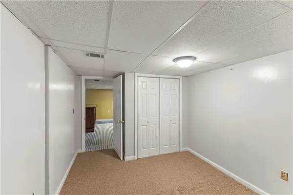 a view of a big room with closet and windows