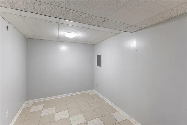 a view of a room with a empty space and windows