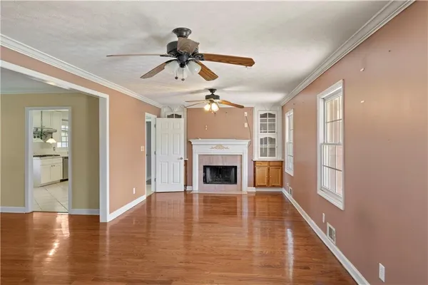 a view of empty room with wooden floor