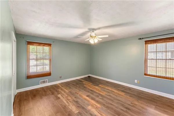 a kitchen with white cabinets and sink