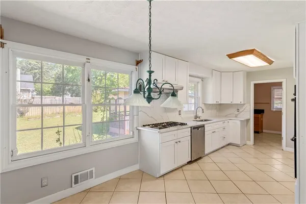 a room with a dresser and a window