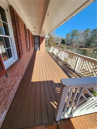 a view of balcony with wooden floor