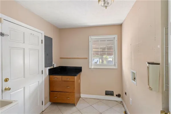 a front view of a house with glass door and furniture
