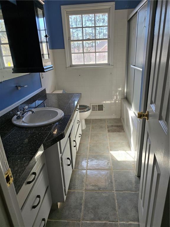 3258 Old Salem Road Southeast Conyers, GA 30013 - Photo 33 of 38 a bathroom with a sink a toilet and a mirror