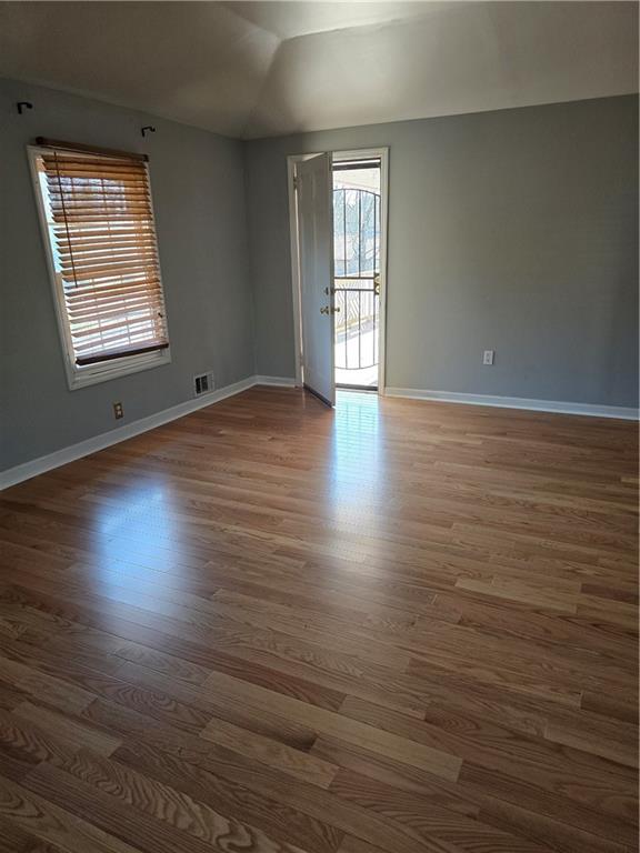 3258 Old Salem Road Southeast Conyers, GA 30013 - Photo 36 of 38 an empty room with wooden floor and windows