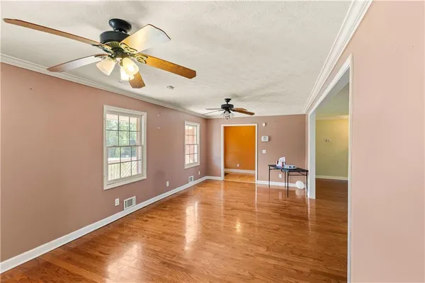 wooden floor in an empty room with a window
