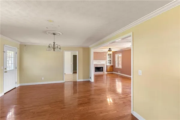 a view of a room with wooden floor and staircase