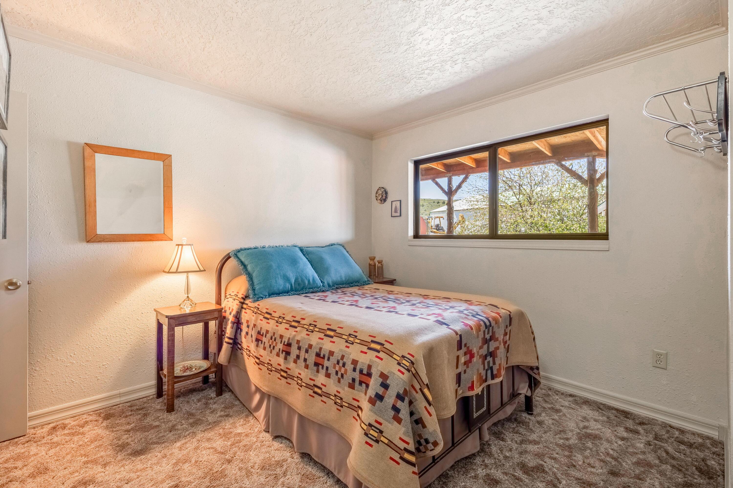 25887 Weberg Road Paulina, OR 97751 - Photo 12 of 46 a bedroom with a bed and a window