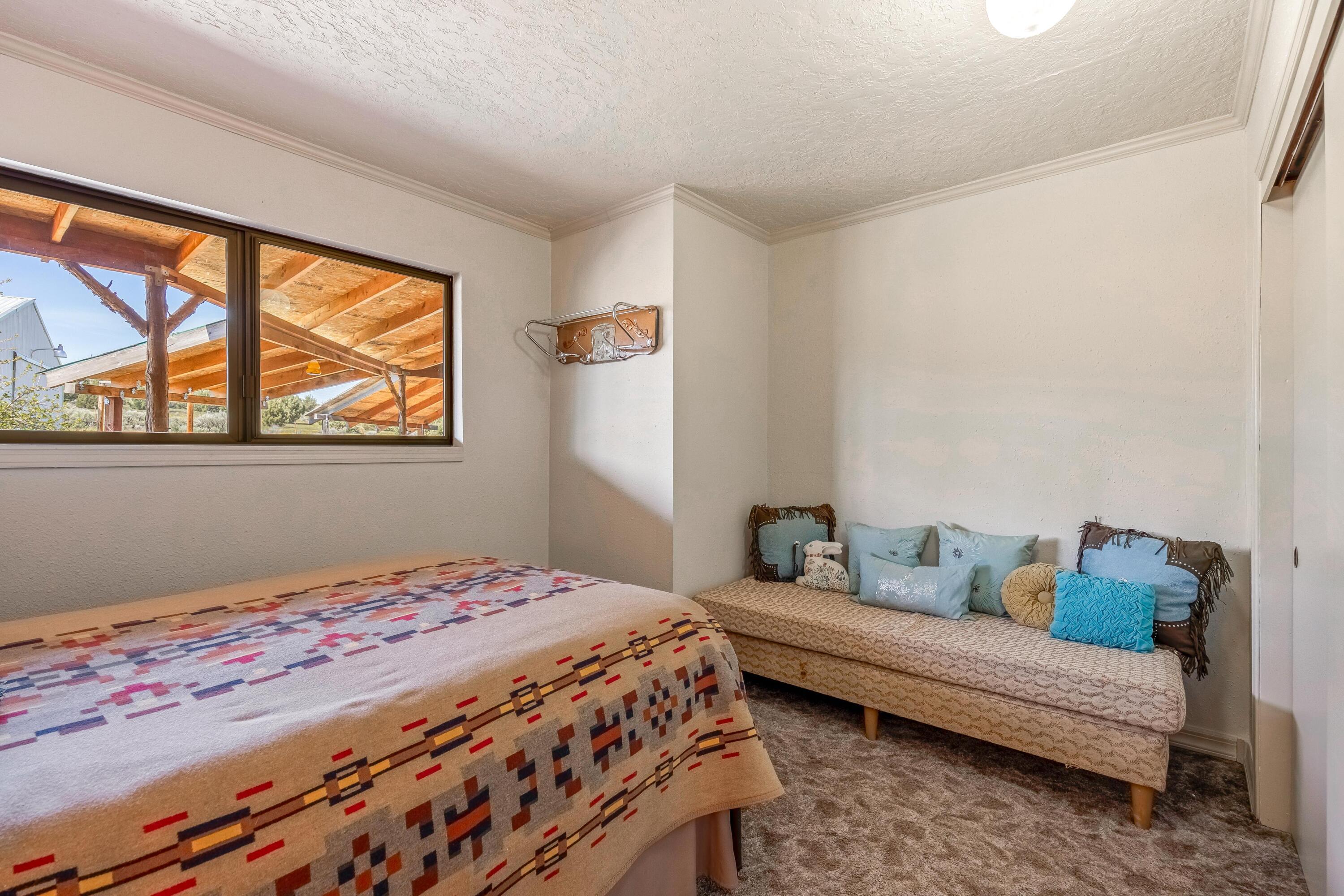 25887 Weberg Road Paulina, OR 97751 - Photo 13 of 46 a bedroom with a bed and wooden floor