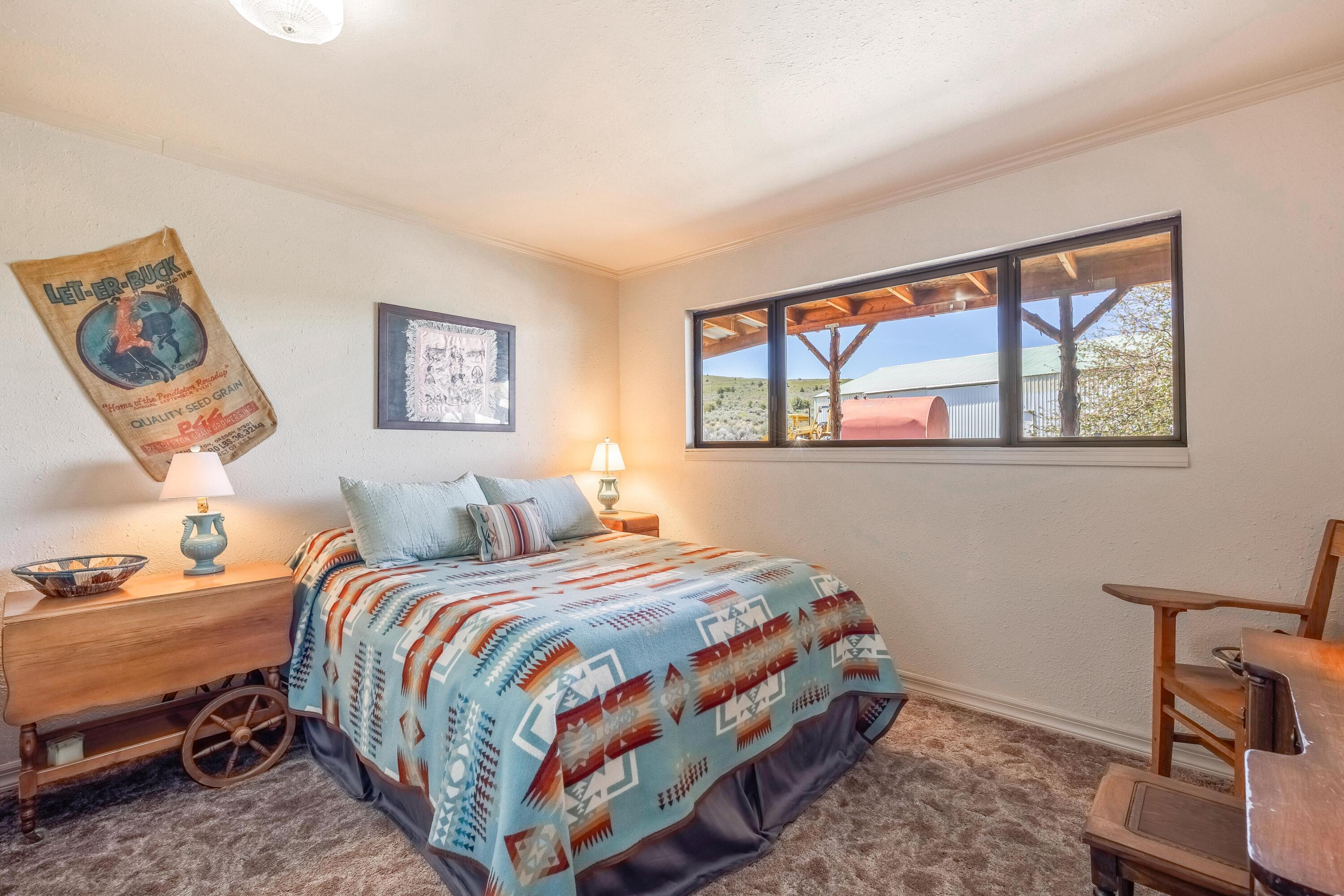 25887 Weberg Road Paulina, OR 97751 - Photo 14 of 46 a bedroom with a bed and a window