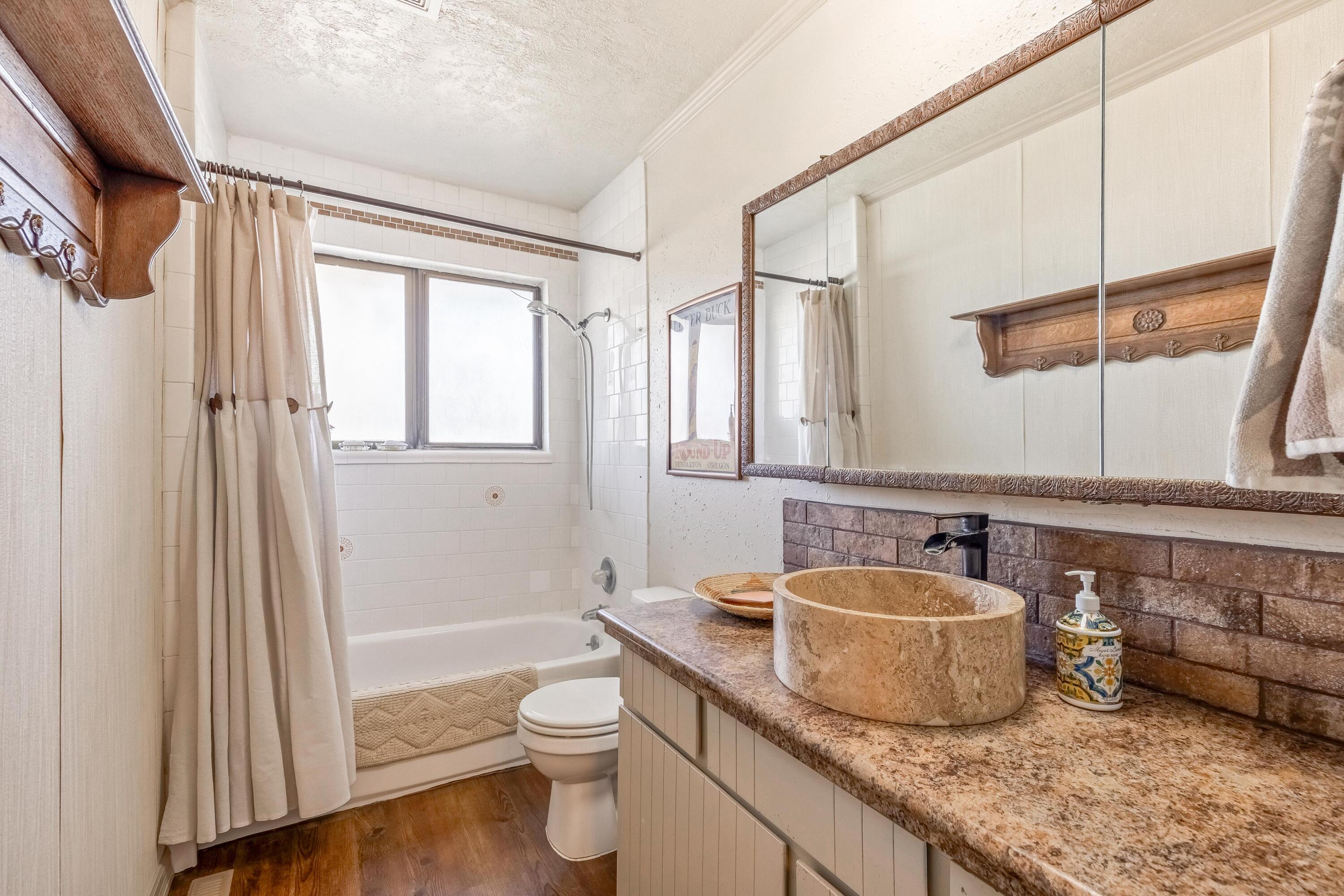 25887 Weberg Road Paulina, OR 97751 - Photo 16 of 46 a bathroom with a granite countertop sink toilet and shower