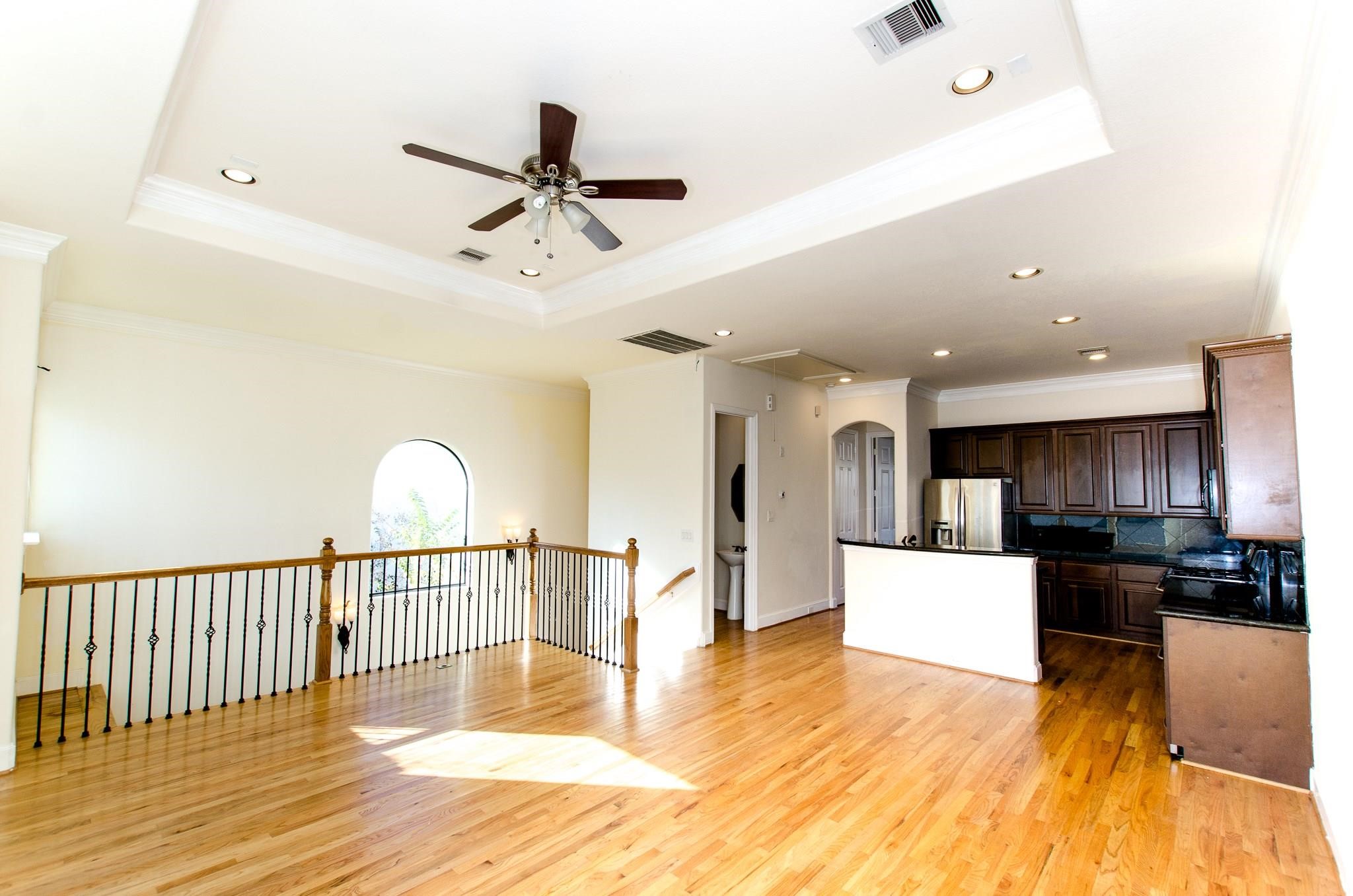 308 Grove Street Houston, TX 77020 - Photo 12 of 28 a view of a living room and kitchen with stainless steel appliances