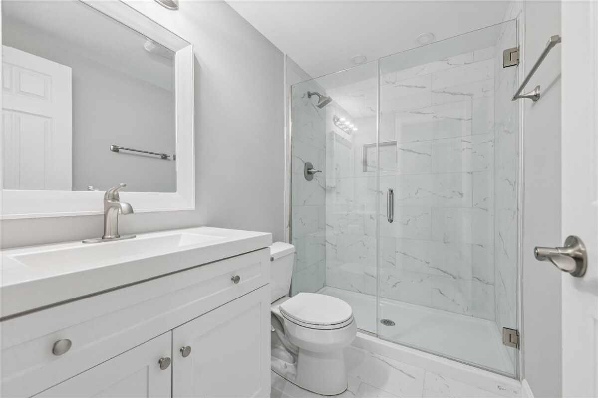 1432 Cascade Lane Barrington, IL 60010 - Photo 15 of 45 a bathroom with a sink a toilet and shower