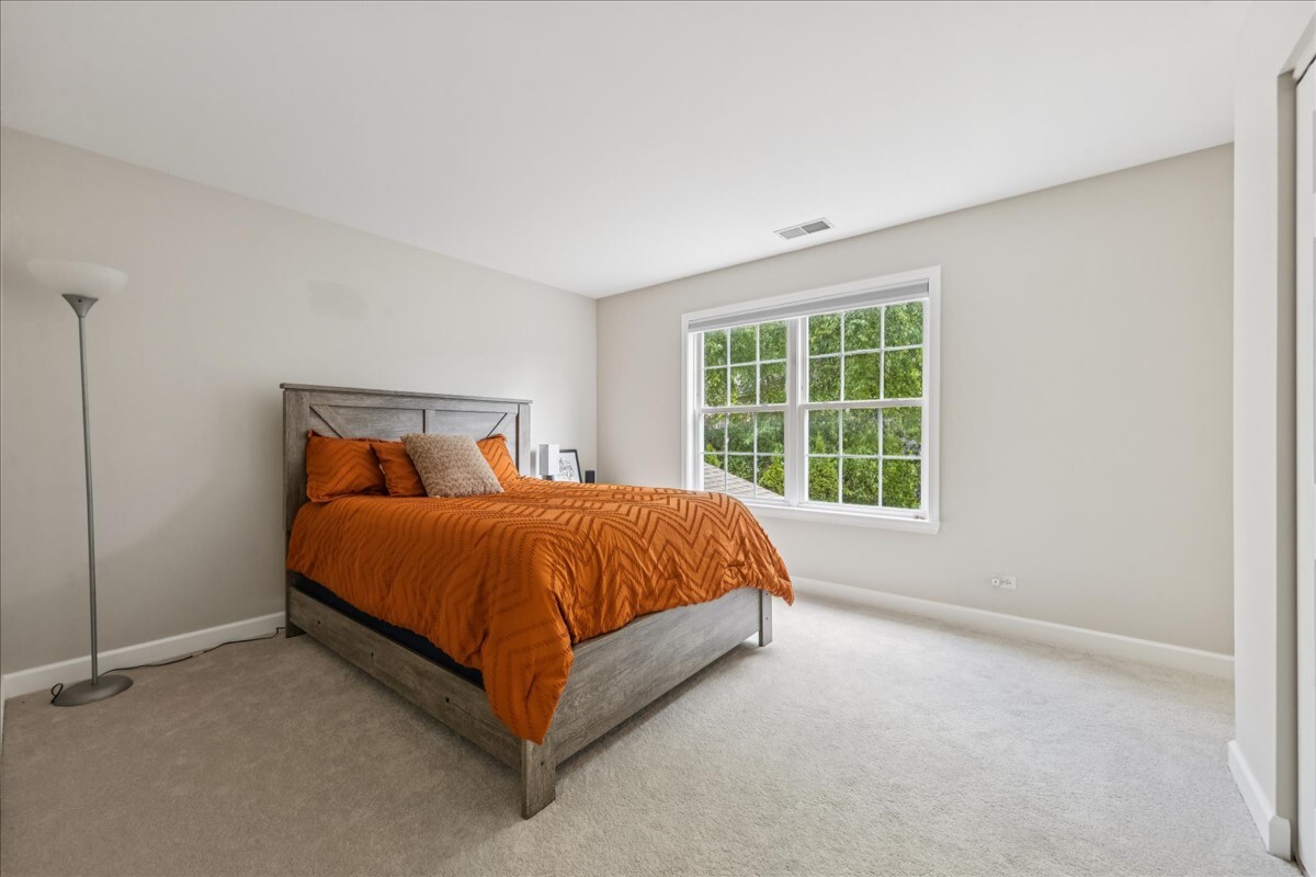 1432 Cascade Lane Barrington, IL 60010 - Photo 28 of 45 a bed sitting in a bedroom next to a window