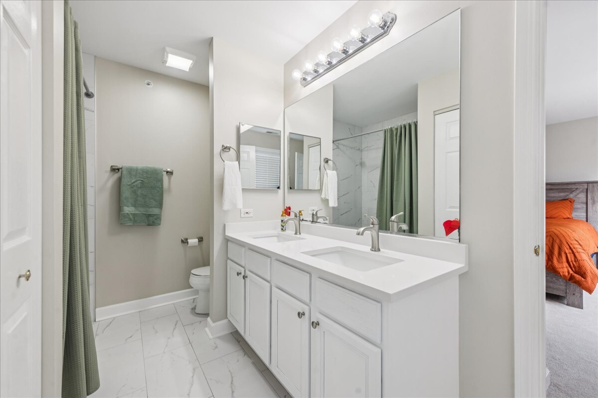 1432 Cascade Lane Barrington, IL 60010 - Photo 29 of 45 a bathroom with a sink a toilet and shower