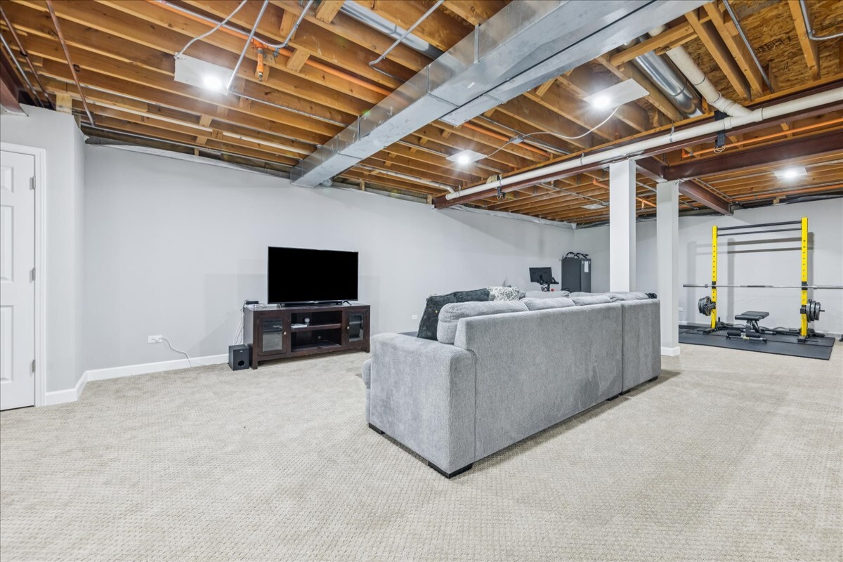 1432 Cascade Lane Barrington, IL 60010 - Photo 31 of 45 a living room with furniture and a flat screen tv