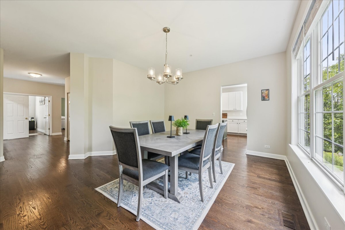 1432 Cascade Lane Barrington, IL 60010 - Photo 6 of 45 a view of a dining room with furniture window and wooden floor