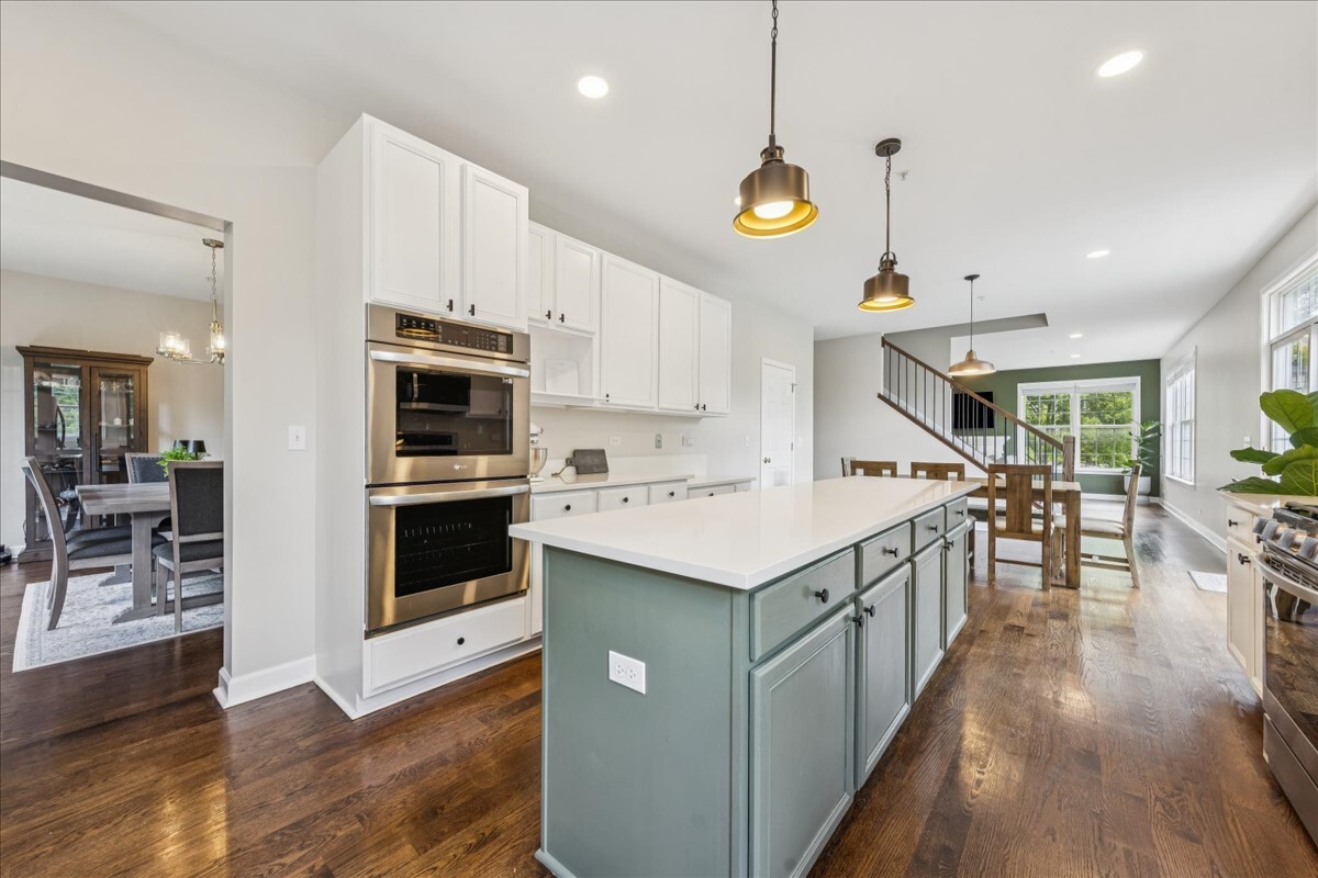 1432 Cascade Lane Barrington, IL 60010 - Photo 7 of 45 a kitchen with stainless steel appliances kitchen island a large island in the center and wooden floors