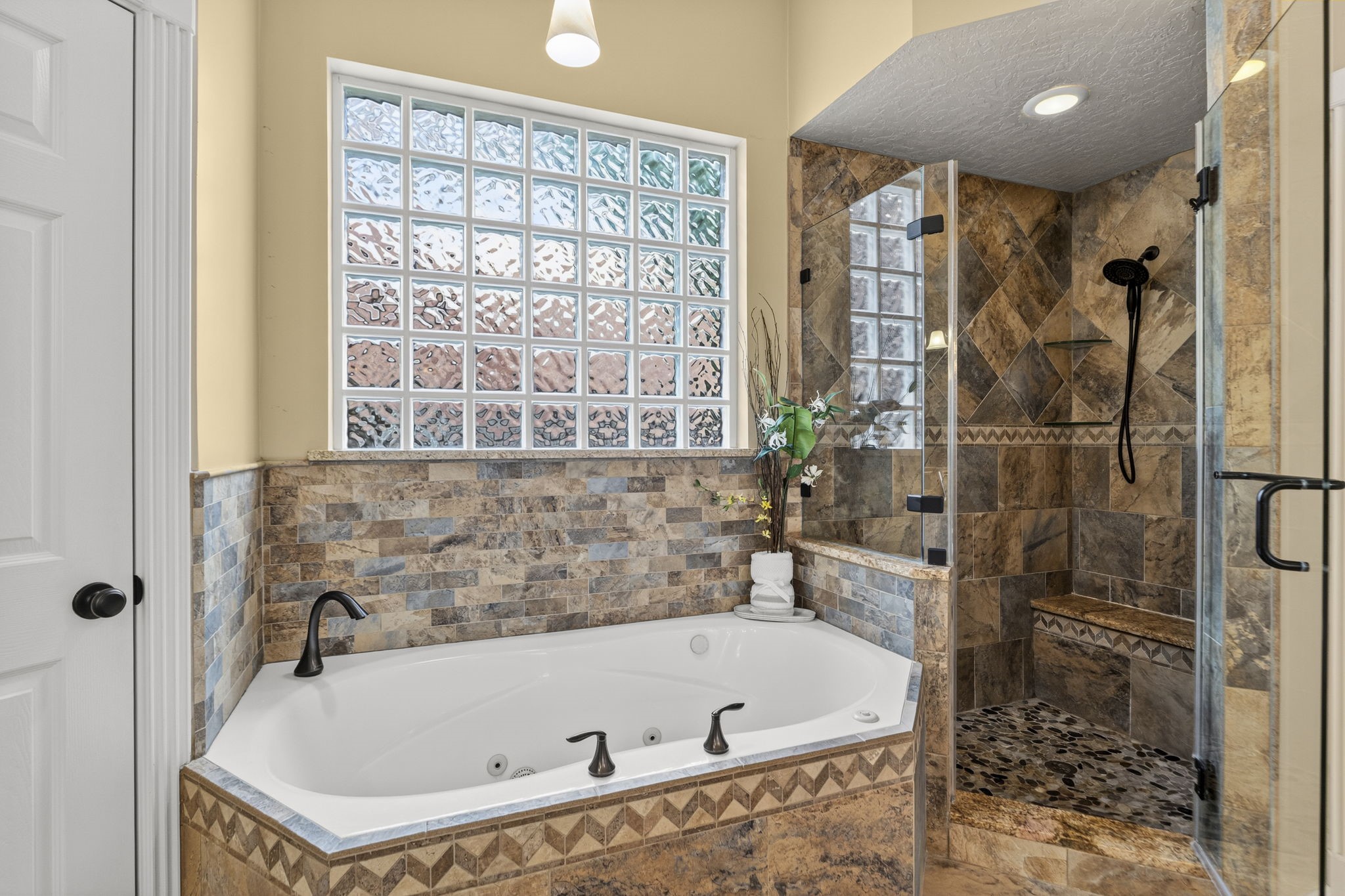 18310 Pamela Way Spring, TX 77379 - Photo 23 of 42 The spacious primary bath features an oversized soaking tub and a separate, modern seamless glass shower.