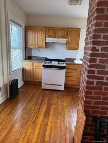 a kitchen with wooden floors and a stove