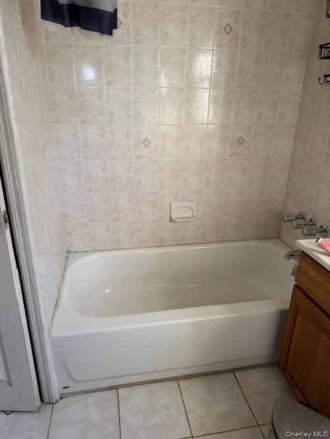 23-01 Enright Road Queens, NY 11691 - Photo 4 of 5 Bathroom featuring vanity, light tile patterned floors, and shower / bath combination