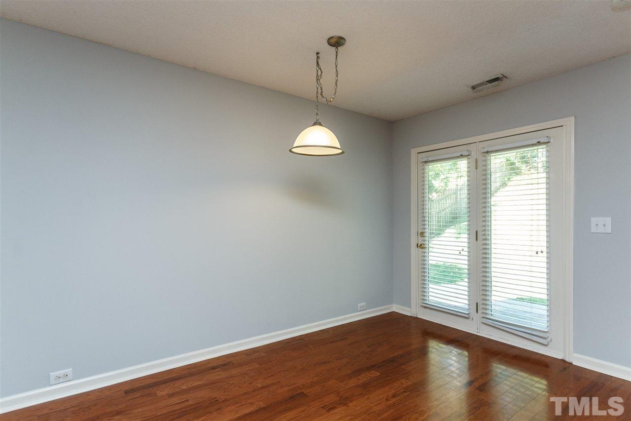 5006 Gable Ridge Drive Durham, NC 27713 - Photo 11 of 24 an empty room with wooden floor and windows