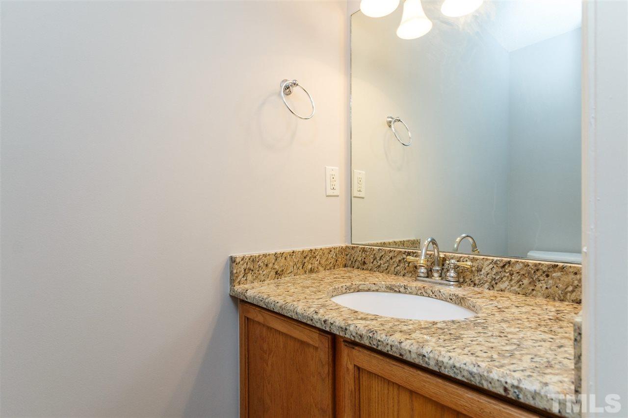 5006 Gable Ridge Drive Durham, NC 27713 - Photo 18 of 24 a bathroom with a granite countertop sink and a mirror