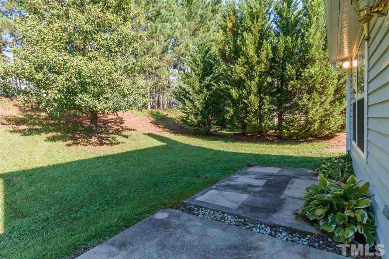 5006 Gable Ridge Drive Durham, NC 27713 - Photo 23 of 24 a view of a yard with plants and a tree