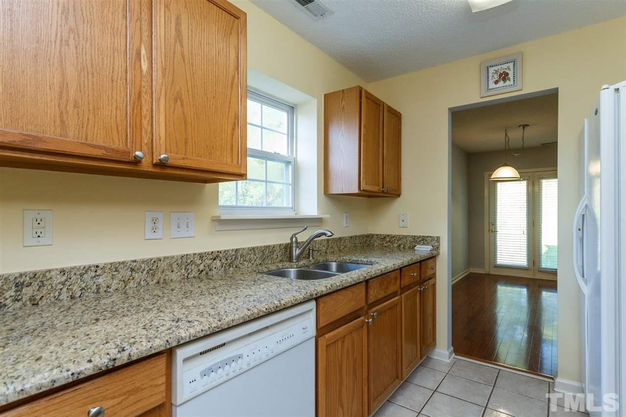 5006 Gable Ridge Drive Durham, NC 27713 - Photo 5 of 24 a kitchen with granite countertop stainless steel appliances sink and cabinets