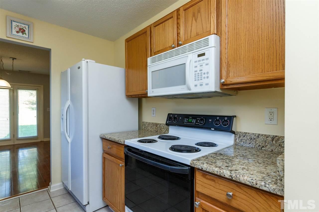 5006 Gable Ridge Drive Durham, NC 27713 - Photo 6 of 24 a kitchen with stainless steel appliances granite countertop a stove and a refrigerator