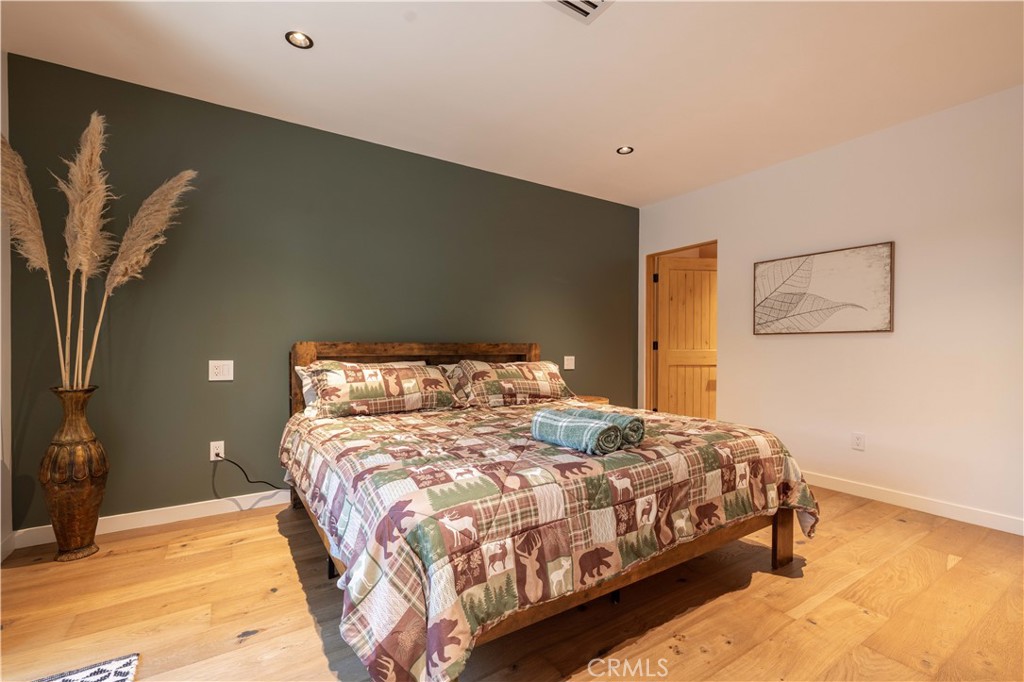 259 Victoria Sugarloaf, CA 92386 - Photo 14 of 32 a large bed sitting in a bedroom next to a cabinet