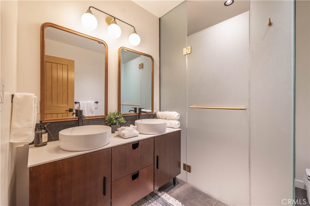 259 Victoria Sugarloaf, CA 92386 - Photo 15 of 32 a bathroom with a double vanity sink and a mirror